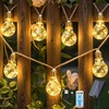 Ollny Guirnalda Luminosa Solar Exterior, 24 Bombillas 12M, Luces Resistentes a la Intemperie, 8 Modos, Temporizador, Regulable, USB, para Jardín Balcón Terraza Boda Fiesta Vintage
